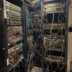 bosway2k_set_of_3_network_racks_on_the_left_in_the_MDF_network__f0e79942-6cb6-4c32-b11b-4f7f41d44e5e